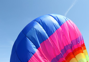 colorful hot air balloon is flying in the blue sky