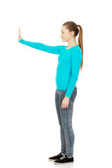 Young woman making stop sign.