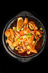 Seafood Prepared In A Frying Pan and black background