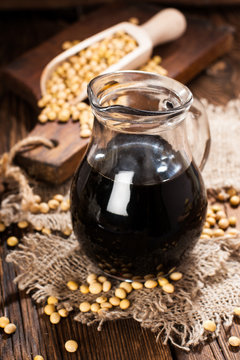 Soy sauce in a decanter on a wooden background. rustic style