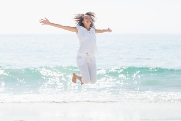 Fototapeta na wymiar happy woman jumping beside the sea 