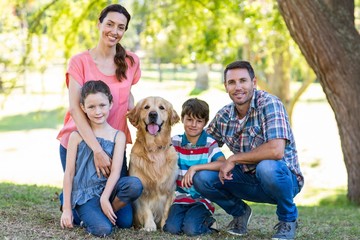 Fototapeta premium Happy family with their dog in the park