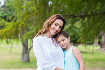 mother and daughter smiling at the camera