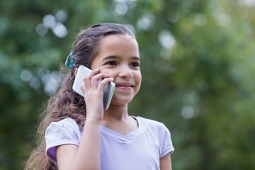 Fototapeta premium Little girl using her phone