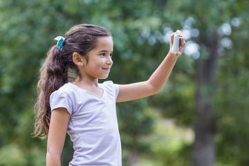 Little girl using her phone
