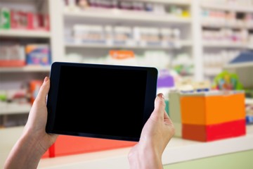 Composite image of finger pointing to tablet