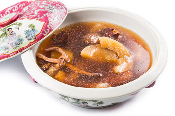 Casserole of Chinese old yellow cucumber soup isolated in white 