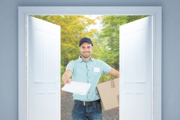 Delivery man with package giving clipboard for signature