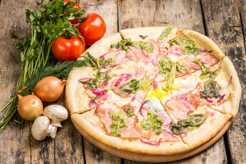Sliced pizza with vegetables around
