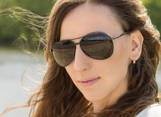 Close up portrait of young woman in black glasses.