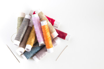 Colored sewing threads on a white table