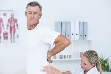 Doctor examining her patient back 