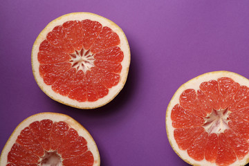 Grapefruits on bright lilac background. Top view