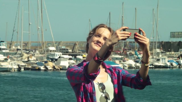 woman model shooting selfie  against of yacht club