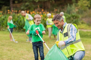 Happy family collecting rubbish 