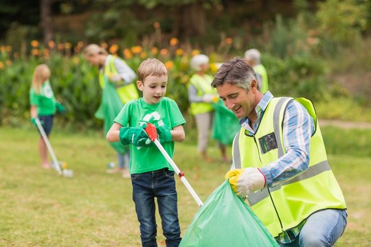 Happy family collecting rubbish 