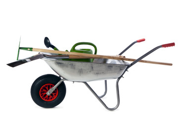 Gardening tools in wheelbarrow isolated on white