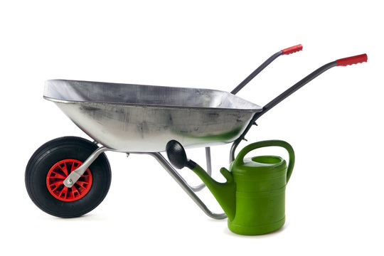 Wheelbarrow and watering can isolated