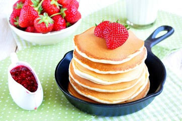 pancakes with fresh strawberry  in a small pan