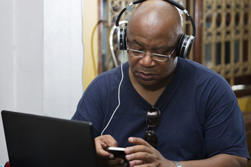 man listening to the music and texting