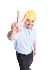 Smiling engineer showing peace sign or number two