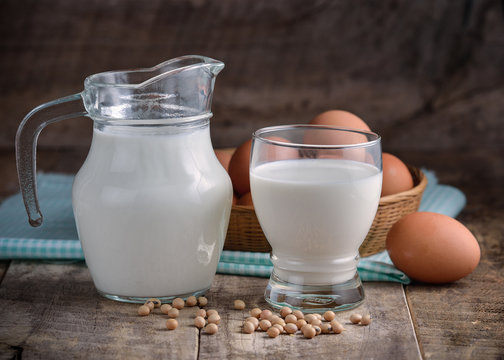 milk egg and soy in a glass on wooden
