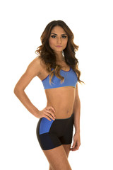 woman in blue fitness attire hand on hip