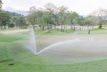 sprinkler water in golf course.