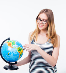 Smiling woman in glasses holding world globe