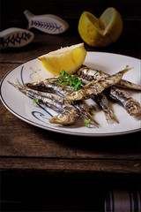 Still life with Grilled Sardines, Herbs and Lemon