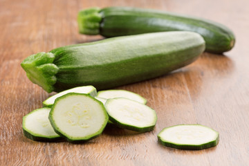slices of green zucchini on wooden table