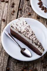 Chocolate dessert with coffee cup and coffee beans on wooden bac