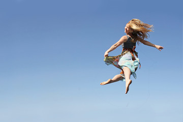 Fototapeta na wymiar Dancing Woman Leaping through the Air