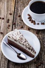 Chocolate dessert with coffee cup and coffee beans on wooden bac
