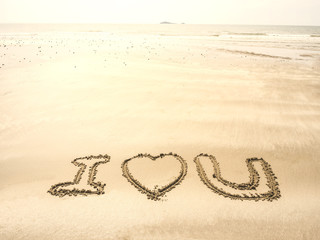 writing on sand in the sea beach