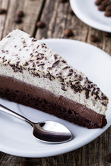 Chocolate dessert with coffee cup and coffee beans on wooden bac