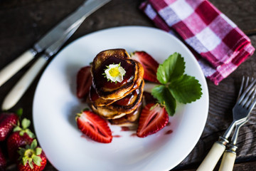 Pancakes with jam and strawberries