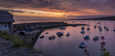Dawn breaking over a harbour with small boats and yachts