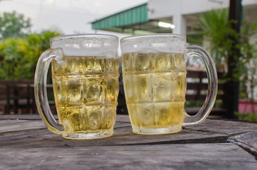 glass of beer with bar scene in the background