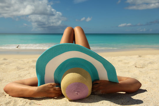 Women Sunbathing On The Beach With Bend Legs