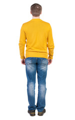 Back view of man in jeans.