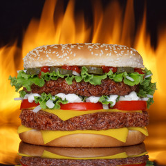Hamburger on black background with real fire