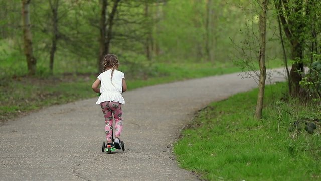 Beautiful girl riding scooter 