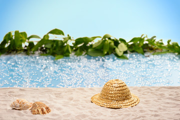 Relaxation at the beach with  sunhat and shells 