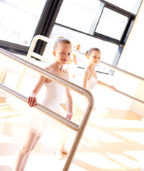 Aspiring young ballerinas practicing at the bar