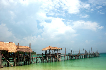 Traditional wooden bridge in Thai style on the beach.