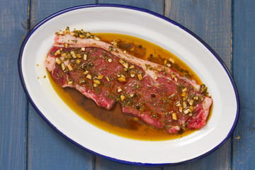 raw meat in sauce on dish