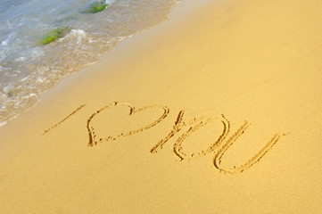 Inscription I love you on a sandy beach
