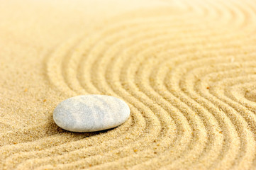 Fototapeta na wymiar Zen stone at of sand background