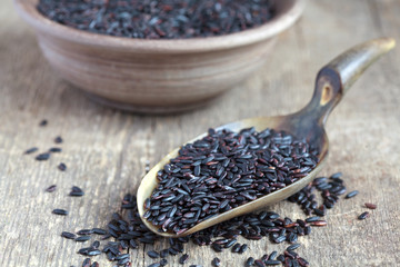 Organic Black Nerone Rice in a scoop on a wooden table